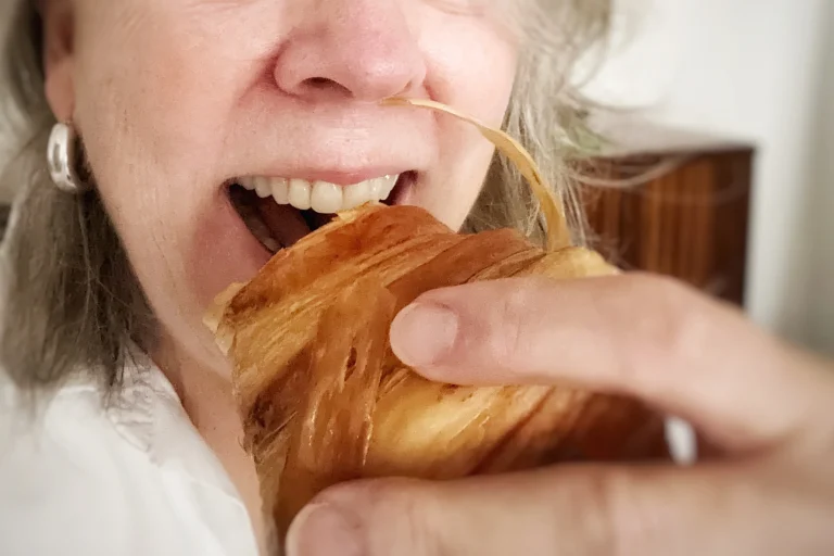 woman eating a croissant, healthy food