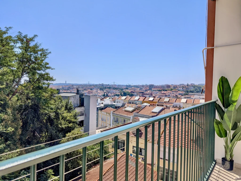 view of Lisbon roof tops from an apartment balcony, buying an apartment in Lisbon