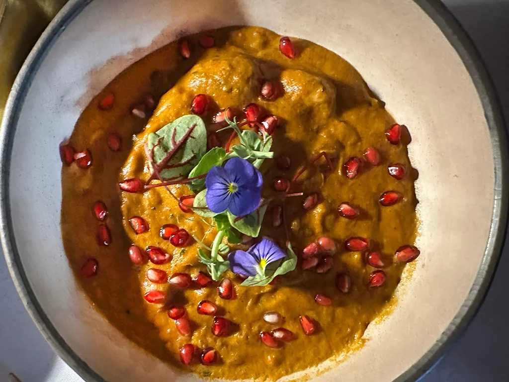 curry dish, orange collars and blue flowers on top. The Oven in Lisbon