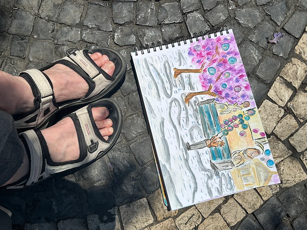 watercolor watercolor drawing on sidewalk, feet wearing sandals