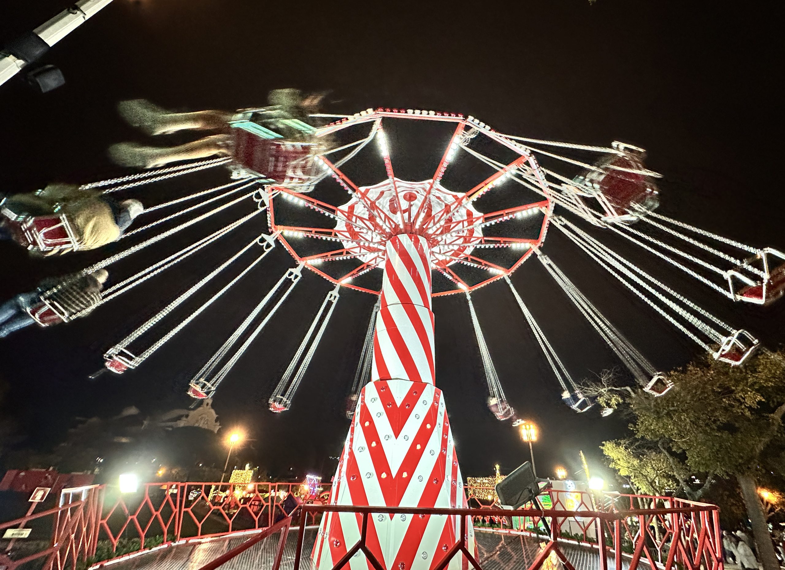 Christmas market in Lisbon, showing a merry go round at night