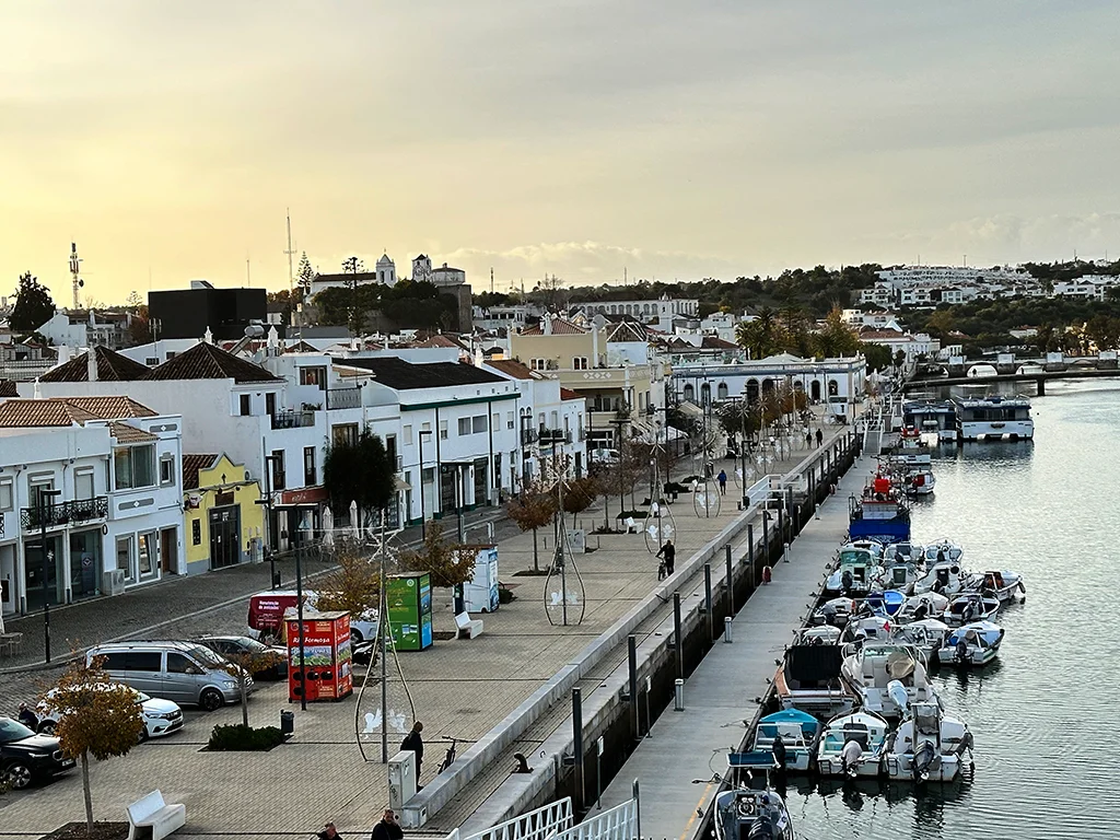 Photo of Tavira main street from a bridge. comercial spots on right and the river on the right