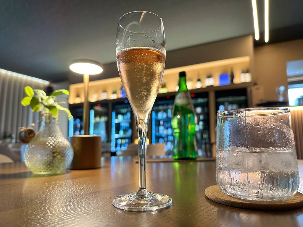 glass of prosecco, glass of water on a table in a restaurant