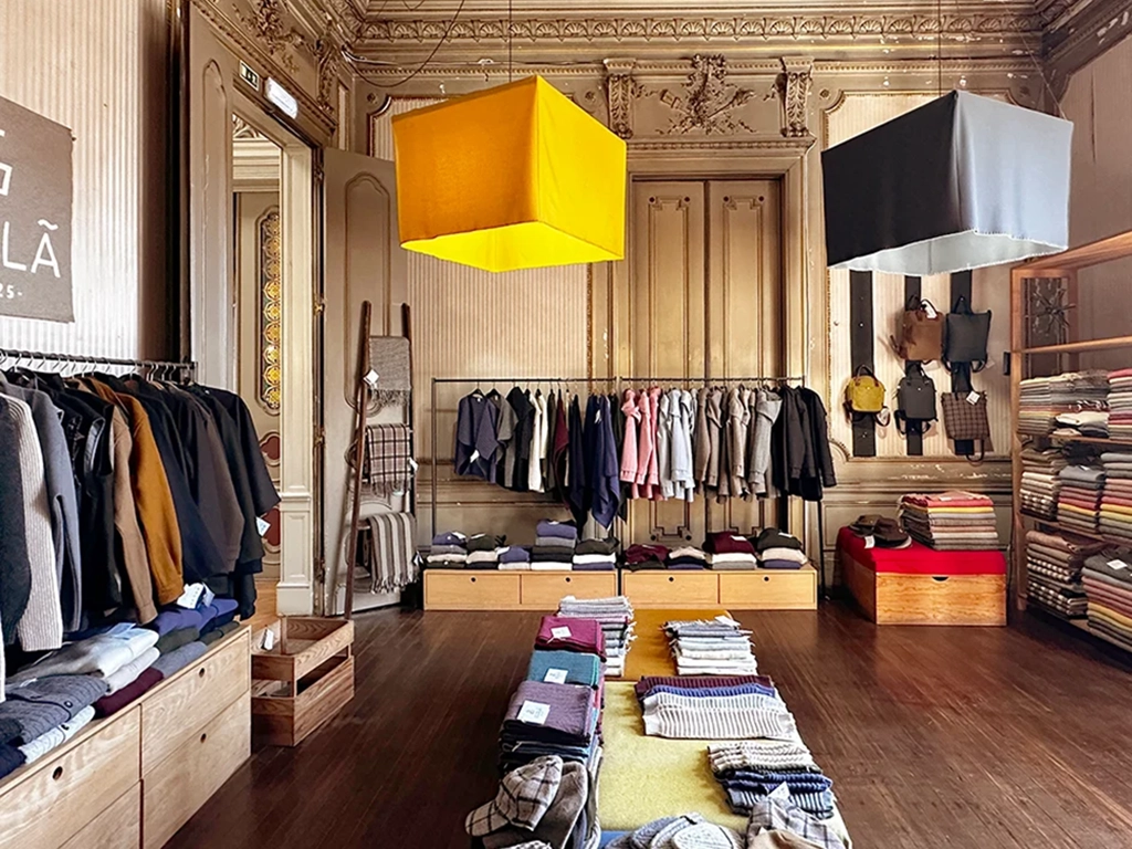 interior of Ecolã store, large lights, merchandise near wall, well lit, Lisbon, 50andRising