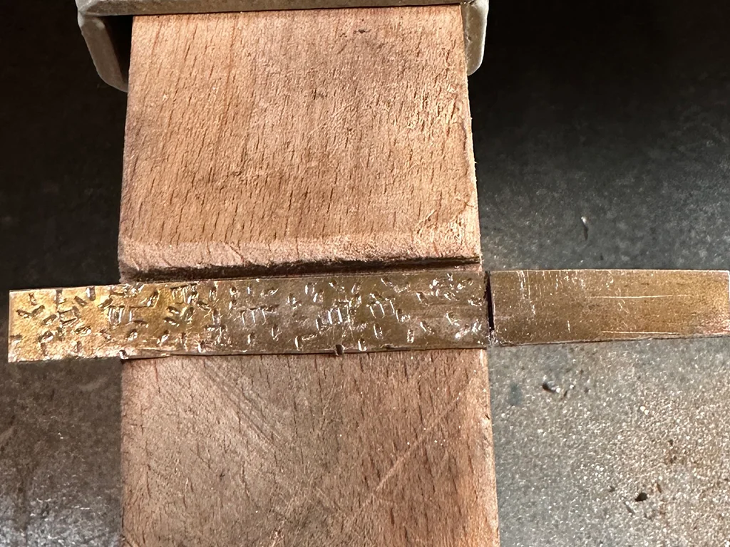 Flat silver with marks on a jeweller bench birthday ring silver